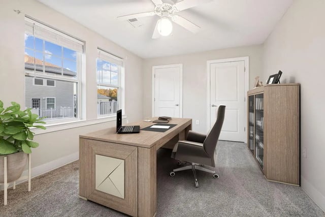 Desk chair laptop and bookshelf study area at Magnolia, A Prosper Community in Tuscaloosa Student Accommodation