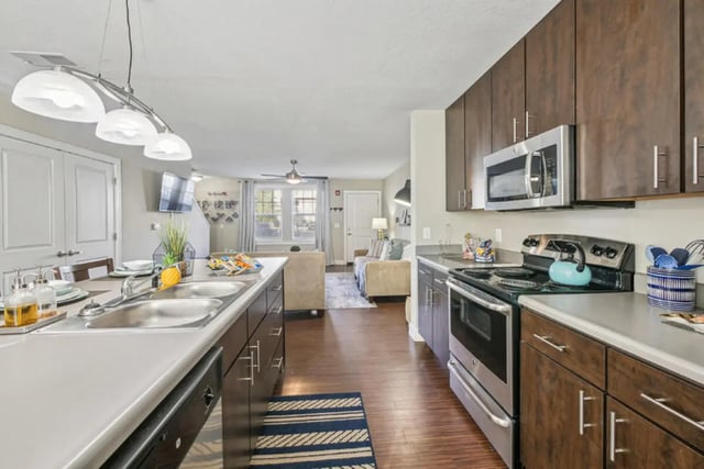 Modern kitchen with island stove and microwave kitchen at Magnolia, A Prosper Community in Tuscaloosa Student Accommodation