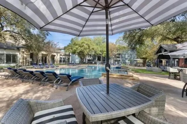Outdoor pool lounge chairs and tables exterior at Mirage San Marcos in San Marcos Student Accommodation
