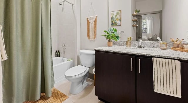 Toilet tub vanity and shower curtain bathroom at Accolade Athens in Athens Student Accommodation