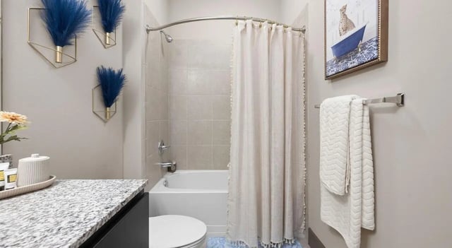 Bathtub shower curtain toilet and artwork Bathroom at Accolade Athens in Athens Student Accommodation