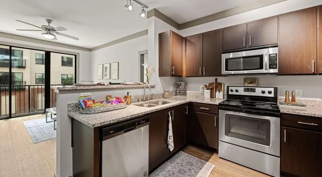 Kitchen with stainless steel appliances and dark cabinets kitchen at Accolade Athens in Athens Student Accommodation