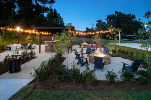 Fire pit lounge chairs volleyball court exterior at Flatts at South Campus in Oxford Student Accommodation