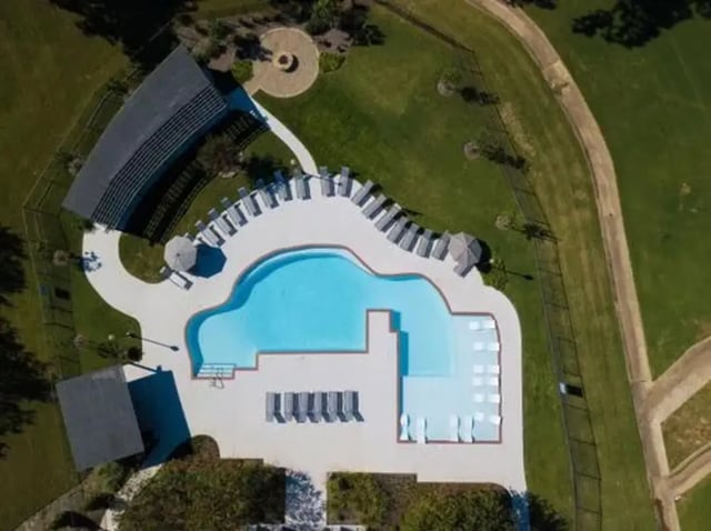 Pool with lounge chairs and umbrellas playing area at Flatts at South Campus in Oxford Student Accommodation
