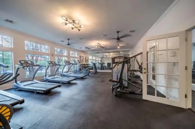 Treadmills weight machines large windows fitness area interior at Flatts at South Campus in Oxford Student Accommodation
