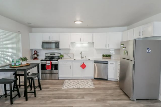 Modern kitchen with white cabinets stainless steel appliances kitchen. at Fleur De Lis Apartments in Provo Student Accommodation