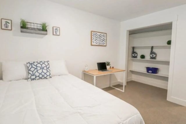 Bed desk laptop and closet interior bedroom at Fleur De Lis Apartments in Provo Student Accommodation