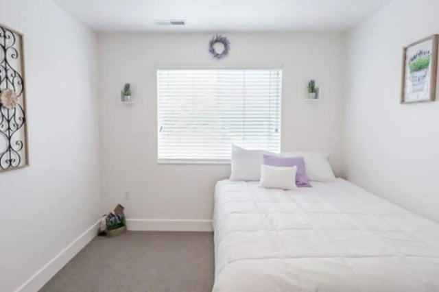 Bed pillows wall art and plants bedroom at Fleur De Lis Apartments in Provo Student Accommodation