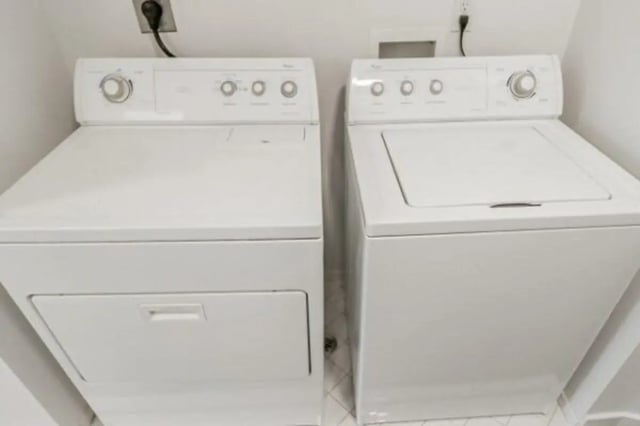 Two white washing machines and dryers laundry area at Fleur De Lis Apartments in Provo Student Accommodation