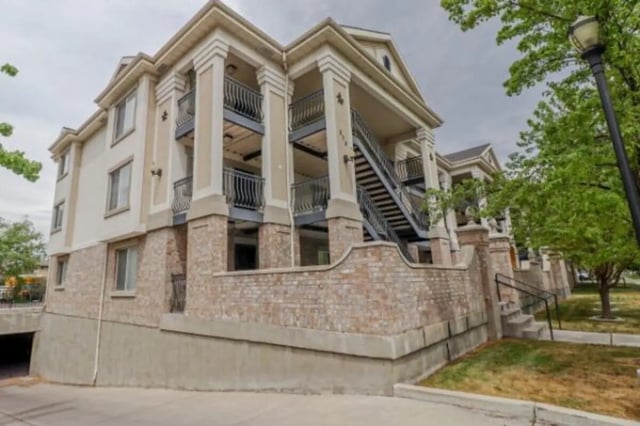 Apartment building with balconies and stairs exterior at Fleur De Lis Apartments in Provo Student Accommodation