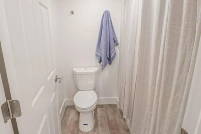 Toilet with blue towel and shower curtain bathroom at Fleur De Lis Apartments in Provo Student Accommodation