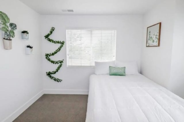 White bed plants garland artwork bedroom at Fleur De Lis Apartments in Provo Student Accommodation