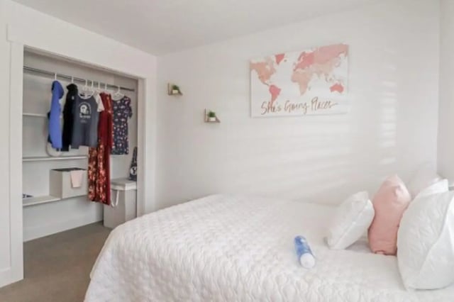 Closet with clothes bed with pillows bedroom at Fleur De Lis Apartments in Provo Student Accommodation