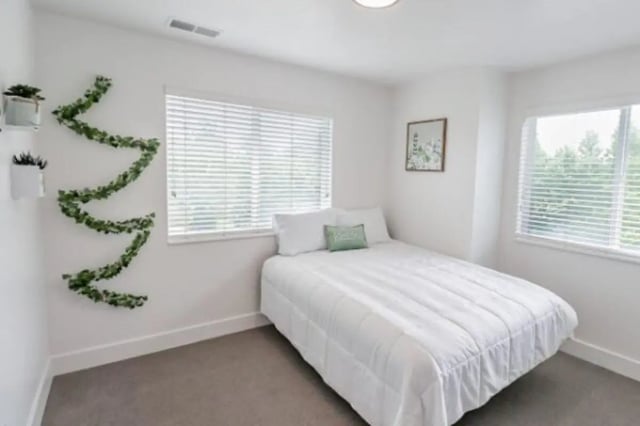 White bed green pillow ivy decor bedroom at Fleur De Lis Apartments in Provo Student Accommodation