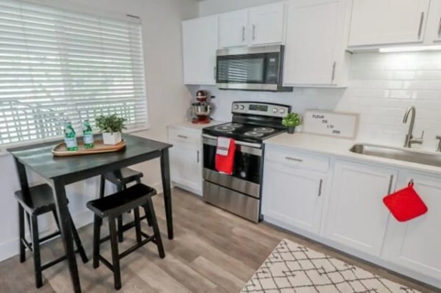 Table chairs oven counter sink kitchen at Fleur De Lis Apartments in Provo Student Accommodation