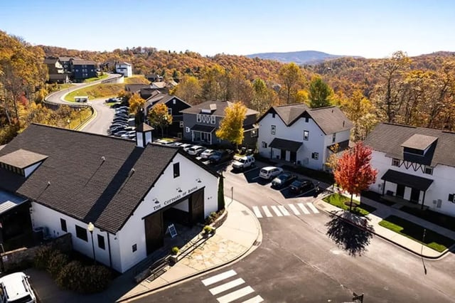 White buildings with cars parked exterior at Highpointe in Boone Student Accommodation