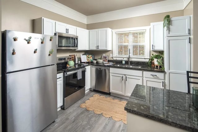 Stainless steel refrigerator oven dishwasher white cabinets kitchen at Highpointe in Boone Student Accommodation