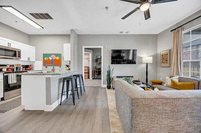 Kitchen island bar stools living room and couch living room at Hill Place Apartments in Fayetteville Student Accommodation