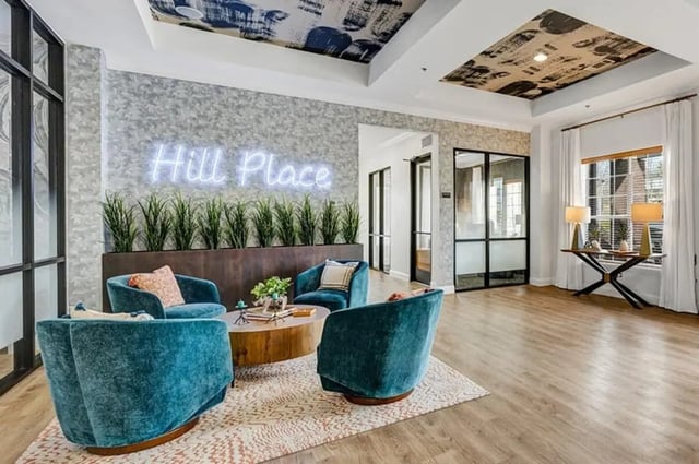 Comfortable seating with neon sign living room at Knights Circle in Orlando Student Accommodation