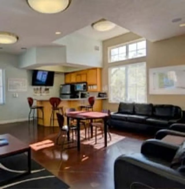 Kitchen island table black couches living room at Knollwood Apartments in Kalamazoo Student Accommodation