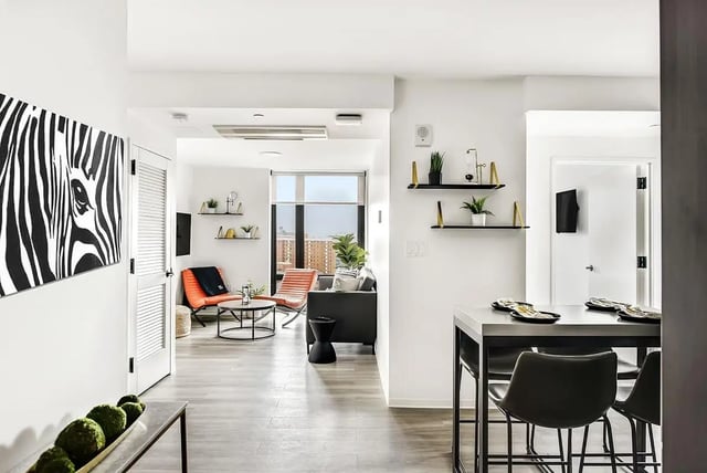 Modern living room with bar dining area Living room at Monarch Heights Apartments