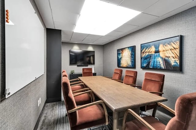 Conference room with whiteboard and large table at Monarch Heights Apartments