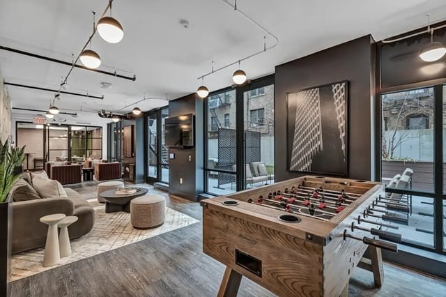 Foosball table sofa and lounge seating common area at Monarch Heights Apartments