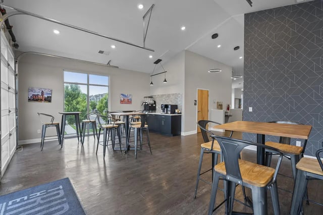Tables chairs coffee station open area living room at The Ridge Clemson in Central Student Accommodation