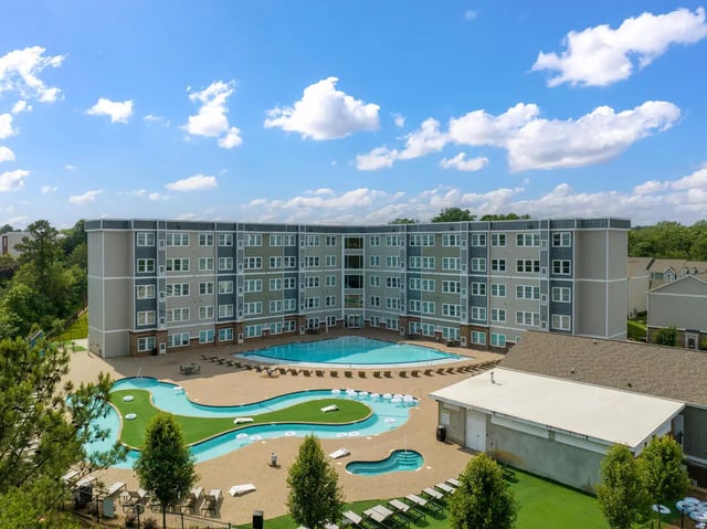 Curved apartment building pools green spaces exterior at The Ridge Clemson in Central Student Accommodation