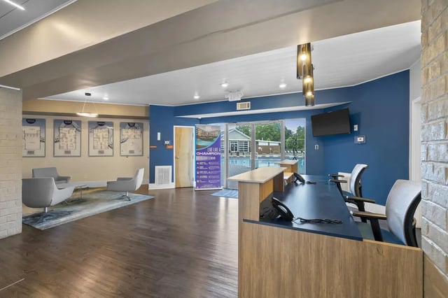 Reception desk with seating and blueprints living room at The Ridge Clemson in Central Student Accommodation