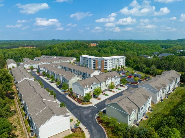 Apartment buildings with trees and parking lot exterior at The Ridge Clemson in Central Student Accommodation