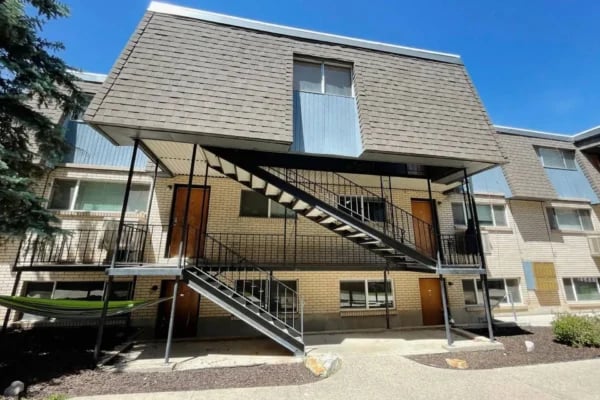 Exterior view of apartment building with stairs and hammocks. at Monticello Apartments in Provo Student Accommodation