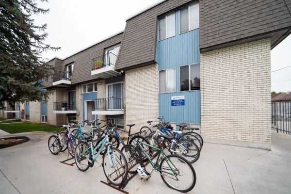 Bicycles parked on pavement outside apartment building Exterior at Monticello Apartments in Provo Student Accommodation