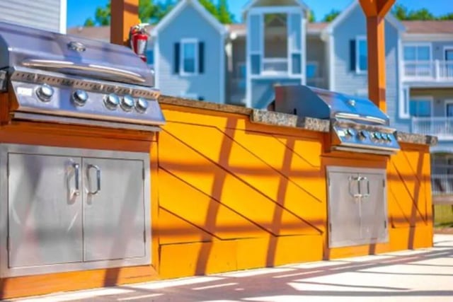 Two grills with cabinets outdoor kitchen area at Pointe At Troy in Troy Student Accommodation