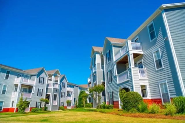 Apartment buildings with balconies and red base exterior at Pointe At Troy in Troy Student Accommodation