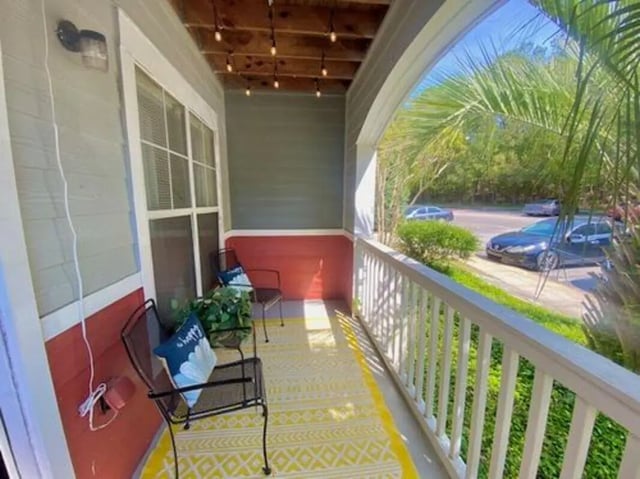 Chairs on yellow rug balcony exterior at Pointe At Troy in Troy Student Accommodation