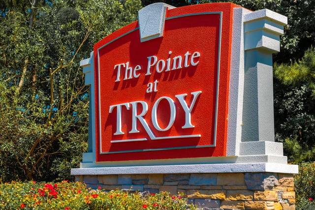 Red sign with The Pointe at TROY exterior at Pointe At Troy in Troy Student Accommodation