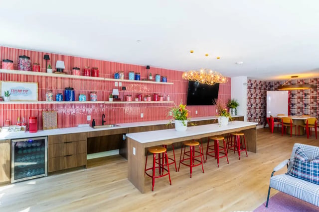 Bar with stools and tv communal area at Pointe San Marcos in San Marcos Student Accommodation