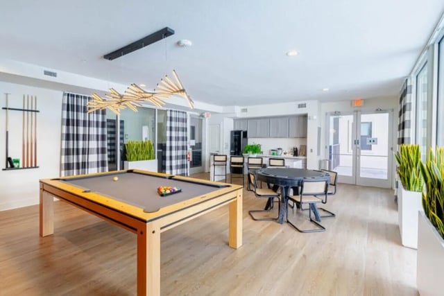 Pool table dining table and kitchen playing area at Pointe San Marcos in San Marcos Student Accommodation
