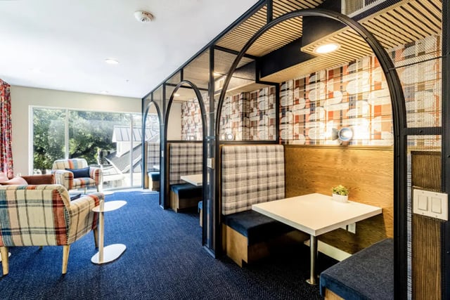 Plaid booths and chairs with tables living room at Pointe San Marcos in San Marcos Student Accommodation