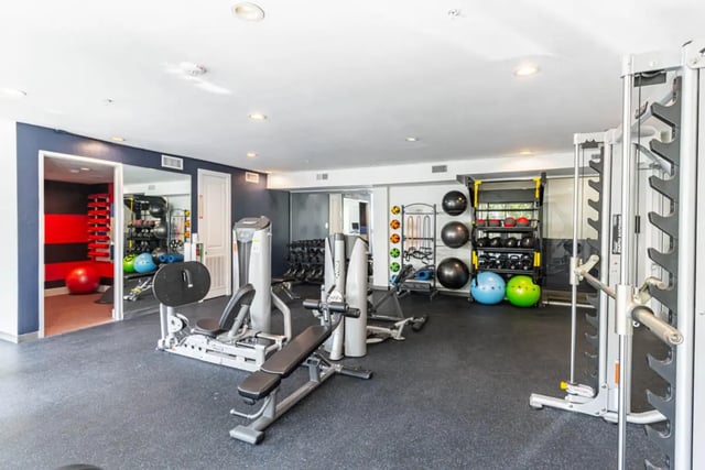 Weights machines medicine balls and exercise equipment gym playing area at Pointe San Marcos in San Marcos Student Accommodation