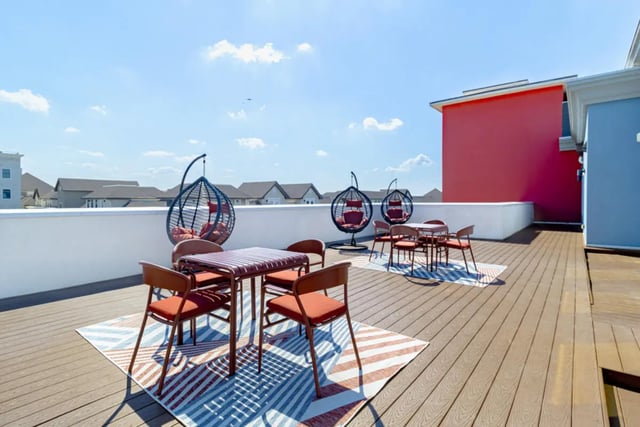 Rooftop deck tables chairs hanging chairs outdoor area at Pointe San Marcos in San Marcos Student Accommodation