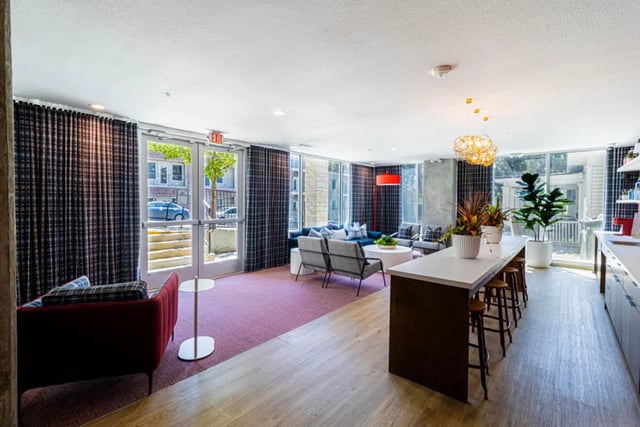 Modern lounge with seating bar area and plants living room at Pointe San Marcos in San Marcos Student Accommodation
