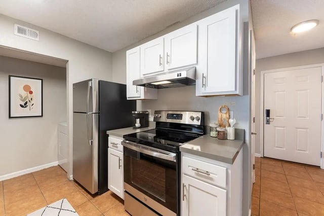 Refrigerator stove cabinets countertop kitchen at ReNew Tallahassee in Tallahassee Student Accommodation