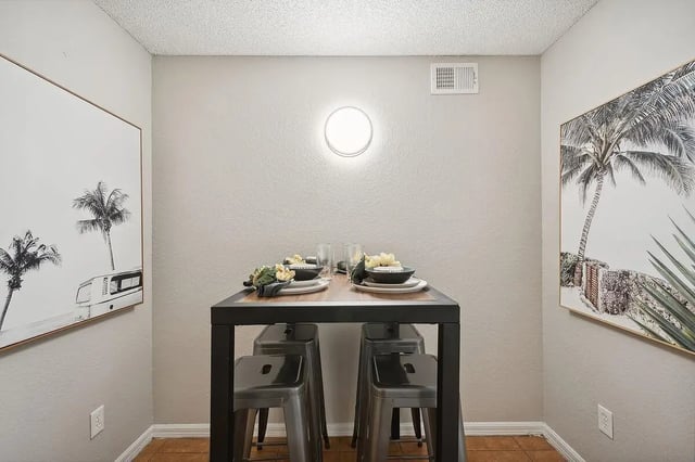 Table with four stools and artwork dining area at ReNew Tallahassee in Tallahassee Student Accommodation