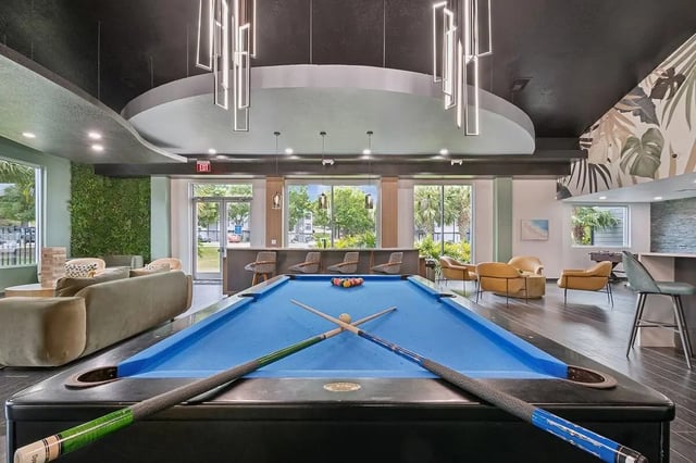 Pool table with cues and balls lounge area playing area at ReNew Tallahassee in Tallahassee Student Accommodation