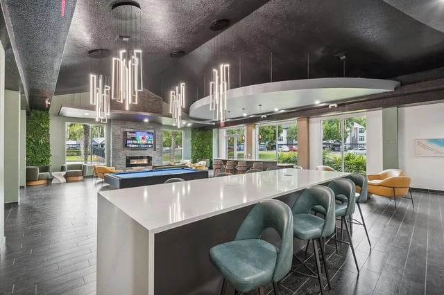 Pool table fireplace bar counter and chairs living room at ReNew Tallahassee in Tallahassee Student Accommodation