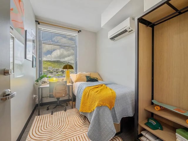 Bed desk chair air conditioner wardrobe bedroom at Hale Mahana in Honolulu Student Accommodation
