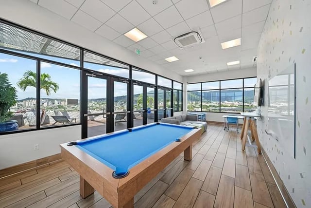 Pool table sofa and tables view living room at Hale Mahana in Honolulu Student Accommodation