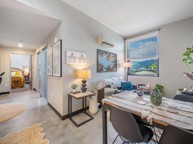 Dining table chairs couch lamp living room at Hale Mahana in Honolulu Student Accommodation